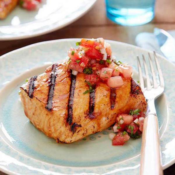 Plate of grilled BC salmon topped with spicy tomato relish